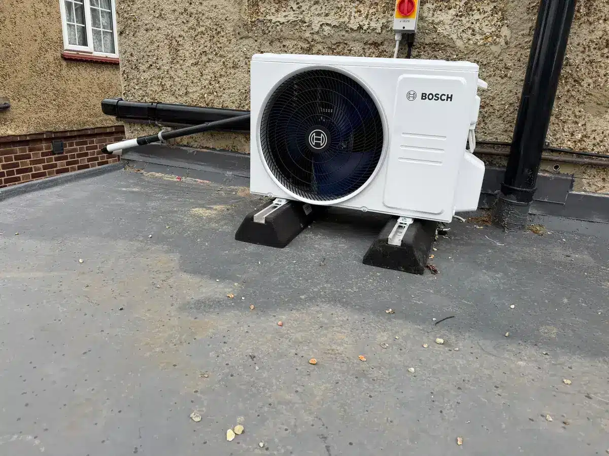 Bosch outdoor air conditioning unit on anti-vibration feet on a flat roof